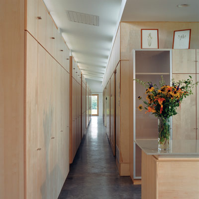 Twenty-eight floor-to-ceiling cabinets from Ikea provide more than 900 cubic feet of storage. Running the entire length of the north corridor, they buffer the colder north side.